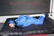 Lucy wearing sexy lightblue downwear tied and gagged with ropes and cloth gag on a bed (Pics)
