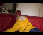 Sonja preparing her sofa with a special shiny nylon cloth wearing a supersexy selfmade shiny nylon shorts in darkblue/purple and a yellow rain jacket (Video)