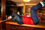Jill tied and gagged in shiny rainwear