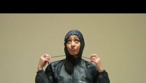 Stella during dressing up for a shooting wearing shiny nylon rainwear (Video)