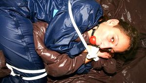 Stella tied and gagged in shiny nylon rainwear