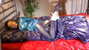 Lulu tied and gagged on bed wearing sexy shiny nylon rainwear (Pics)