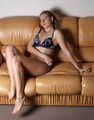 Topless cleavegagged Albina Rose, cuffed with steel handcuffs and legcuffs, poses on the couch