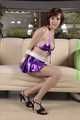 Danny bound in a shiny purple Skirt and Bra, gagged with a Silkscarf