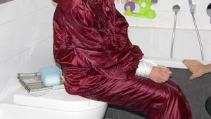 Isabelle tied and gagged in a shiny downwear