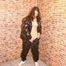 Brown-haired sexy archive girl posing on a wall wearing supersexy black shiny nylon rainwear (Pics)