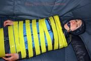 Katharina taped and gagged in a blue nylon rainsuit