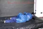 Lucy tied with cuffs overhead and gagged with a clothgag wearing sexy blue rain pants and a raincoat (Pics)