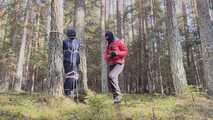 Sebastien breathplay tied up in a puffer jacket among the trees.
