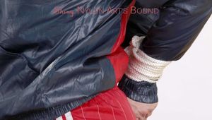 Jill tied and gagged on a bed wearing red shiny nylon shorts(Pics)