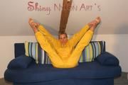 Sexy blonde archive girl posing and lolling on a sofa wearing sexy yellow rainwear over nothing (Pics)