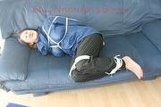 Katharina tied, gagged and hooded (breath control) on a sofa wearing sexy shiny nylon rainwear (Pics)