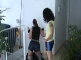 One archive girl tied, gagged and spanked by another one on a stair rail (Video)