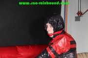 Sexy PIA wearing a sexy blue rainbib and a black/red shiny nylon rainjacket being tied, gagged and hooded on a chair with ropes and a ballgag (Pics)