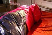 Mara in bed wearing supersexy pink shiny nylon downjacket with hood and a rain pants (Pics)