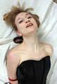 Amanda in leather corset and knee socks, frogtied with her hands in reverse prayer