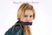 Samantha bound and gagged in a green shiny nylon shorts with green rain jacket and lycra leggings
