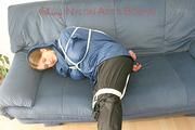Katharina tied, gagged and hooded (breath control) on a sofa wearing sexy shiny nylon rainwear (Pics)