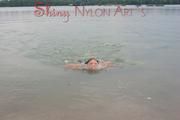 Stella posing and lolling in a sexy green shiny nylon adidas shorts outdoor in and on a lake (Pics)