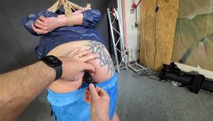 Lena buttplugged, bound and gagged in shiny Shorts and Windbreaker
