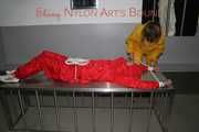 Watching Stella being tied and gagged with ropes and a ballgag on a operating table from Leonie both wearing sexy shiny nylon rainwear (Pics)