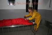 Watching Stella being tied and gagged with ropes and a ballgag on a operating table from Leonie both wearing sexy shiny nylon rainwear (Pics)