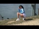 Stella on a lake wearing shiny nylon shorts and rain jacket (Video)