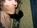 28 YEAR OLD HOUSEWIFE IS MOUTH STUFFED, WRAP TAPE GAGGED, TOE-TIED,  BLINDFOLDED, and HOG-TIED (D57-14)