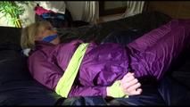 Pia tied and gagged on a bed with shiny nylon cloth wearing a supersexy purple rainjacket and rainpants (Video)