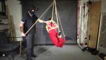 Marie bound, gagged and suspended in a shiny nylon Jumpsuit