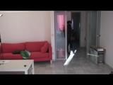 Enni with black shiny nylon shorts and rain pants and a rain jacket over naked skin smoking a cigarette (Video)