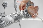 Simone in an shiny grey pvc sauna suit tied and gagged by Sophie in the bath tub (pics)