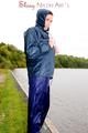 Sexy archive girl wearing a blue rain pant and rain jacket walking on a lake in freetime (Pics)