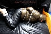 Jill tied and gagged in a shiny nylon down coat