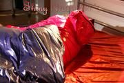 Mara in bed wearing supersexy pink shiny nylon downjacket with hood and a rain pants (Pics)