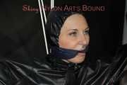 Sexy Mara tied, gagged and hooded overhead on hands and feet with ropes and a cloth gag wearing a sexy black/pink rainwear combination (Pics)