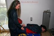 Jill tied and gagged by Petra both in shiny nylon rainsuits