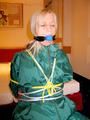 Blonde archive girl tied and gagged in an green shiny nylon rainsuit on a chair (Pics)
