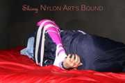 Watching Pia wearing blue/pink shiny nylon rainwear being tied and gagged and hooded with tape and a clothgag (Pics)