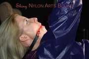 Watching sexy Pia wearing a sexy blue oldschool shiny nylon shorts and a rain jacket being tied and gagged on hands and feet on the ceiling lying on the floor (Pics)