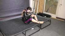 Lana handcuffed and gagged wearing a shiny nylon Windbreaker