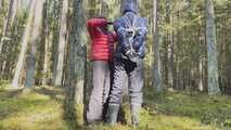 Sebastien breathplay tied up in a puffer jacket among the trees.