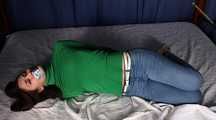 Roxana hogtied on bed