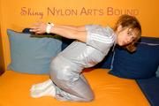 Beautiful archive girl tied and gagged wearing a shiny grey nylon jumpsuit(Pics)
