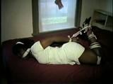 26 YR OLD BLACK BANK TELLER IS HOG-TIED, CLEAVE GAGGED AND HANDGAGGED WHILE STRUGGLING ON THE BED (D52-12)