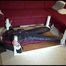 Mara tied and gagged on a bottom-up table wearing a supersexy black/red downwear combination (Video)