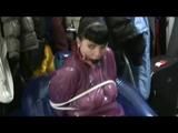 Video with Jill tied and gagged in a shiny purple semi transparent PVC suit