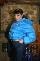 Jill posing in a cooling room wearing a shiny nylon rainpants and a down jacket (Pics)