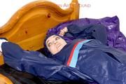 Jill tied and gagged in shiny nylon rainware
