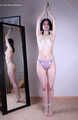Tracy: topless barefoot girl with noose on her neck, having her to stand on her tip toes to breathe, is tickled by camera man